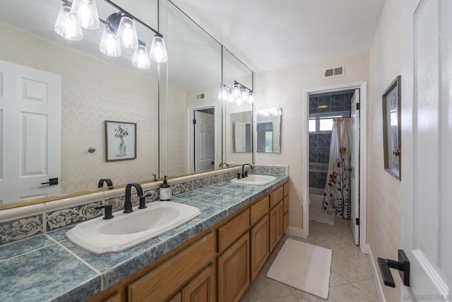 bathroom featuring tile patterned flooring, shower / tub combo, and vanity