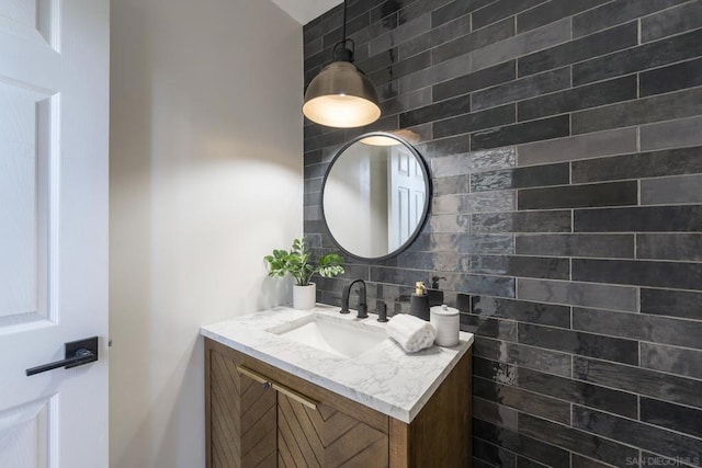 bathroom featuring vanity, backsplash, and tile walls