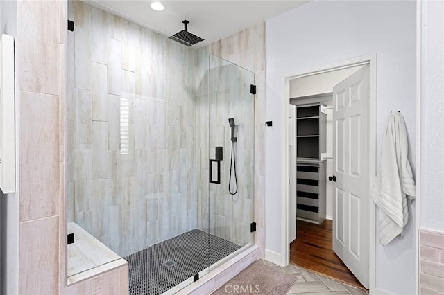 bathroom with parquet flooring and a shower with door