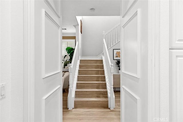 staircase with wood-type flooring