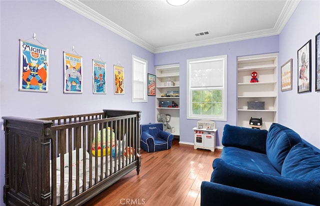 bedroom with hardwood / wood-style flooring and crown molding