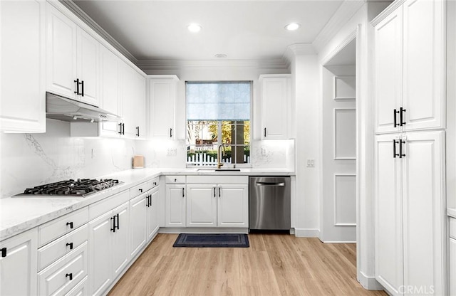 kitchen featuring sink, white cabinets, stainless steel appliances, and light hardwood / wood-style flooring