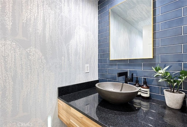 bathroom featuring vanity and tile walls