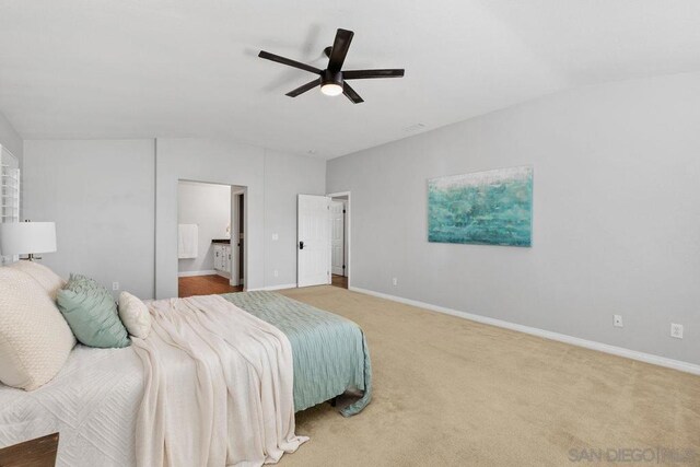 bedroom featuring ceiling fan, carpet, and ensuite bath