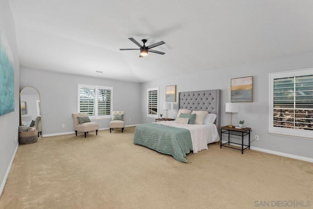 bedroom featuring light colored carpet, vaulted ceiling, and ceiling fan