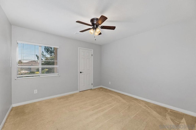 carpeted empty room featuring ceiling fan