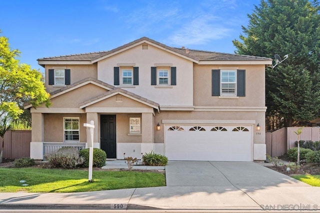 front of property featuring a garage and a front lawn