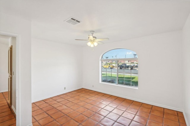 tiled spare room featuring ceiling fan