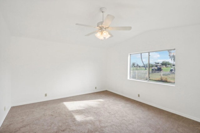 carpeted empty room with vaulted ceiling and ceiling fan