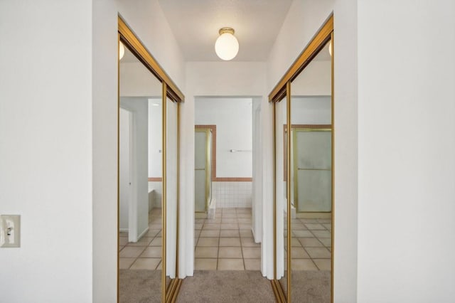 hall featuring light tile patterned floors