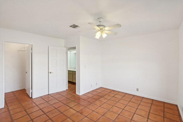 interior space with a closet, ceiling fan, and light tile patterned flooring