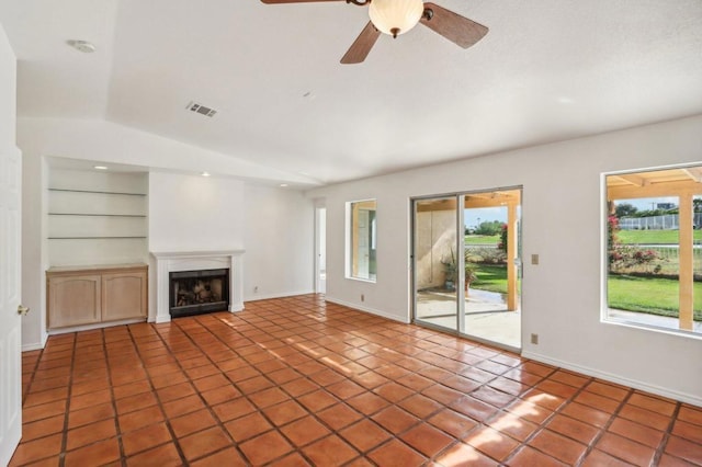 unfurnished living room featuring ceiling fan, lofted ceiling, built in features, and tile patterned floors