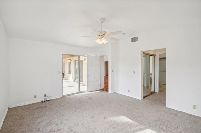 carpeted spare room with ceiling fan