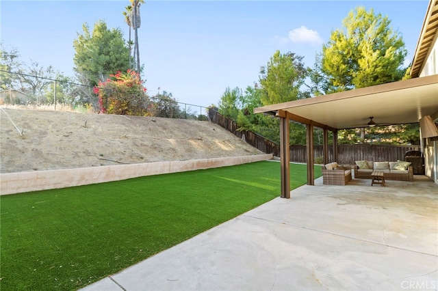 view of yard with an outdoor living space, ceiling fan, and a patio