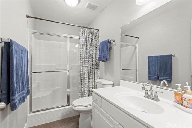 bathroom with toilet, wood-type flooring, vanity, and a shower with curtain