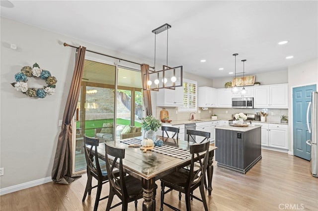 dining area featuring sink and light hardwood / wood-style floors