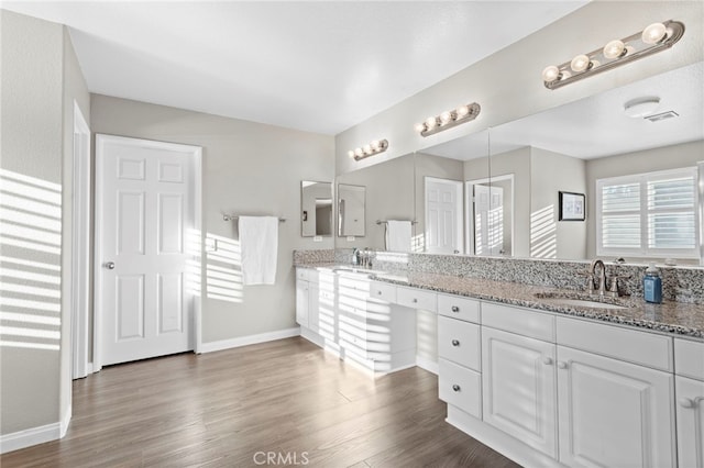 bathroom with vanity and wood-type flooring