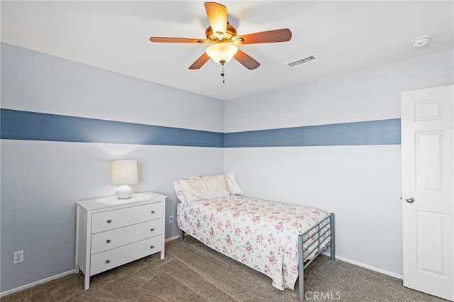 bedroom with ceiling fan and dark carpet