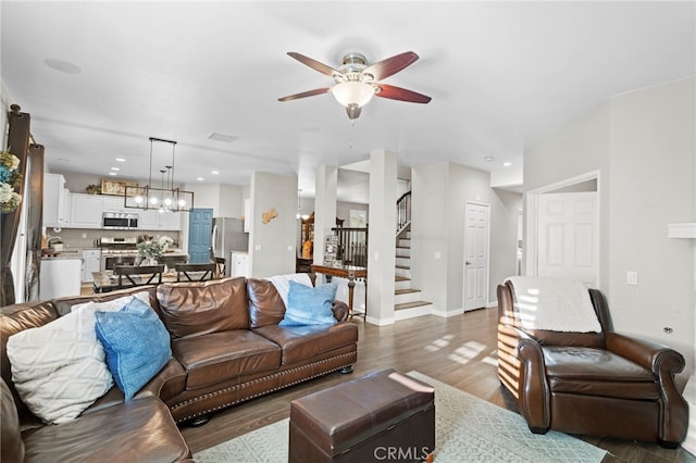 living room with dark hardwood / wood-style floors and ceiling fan