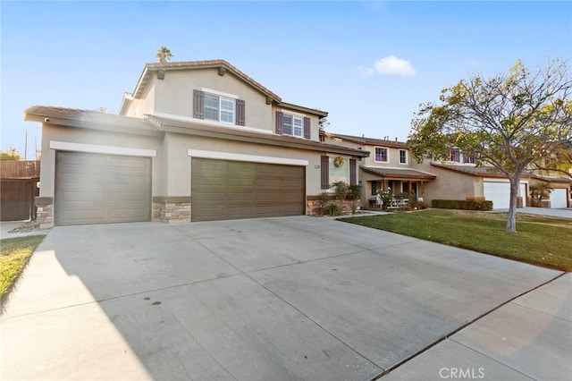 view of front of house featuring a garage and a front lawn