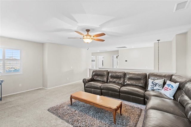 carpeted living room with ceiling fan