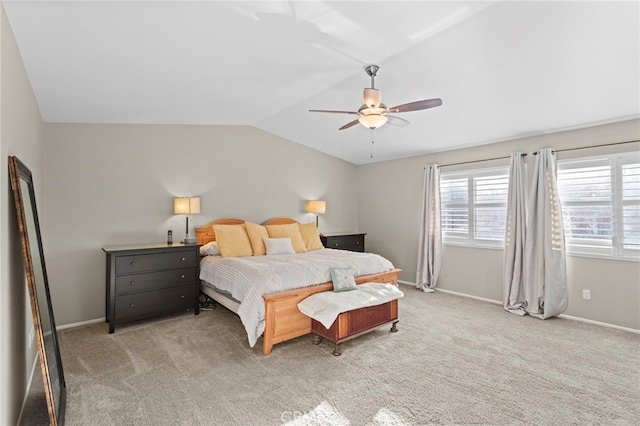 bedroom with ceiling fan, carpet floors, and vaulted ceiling