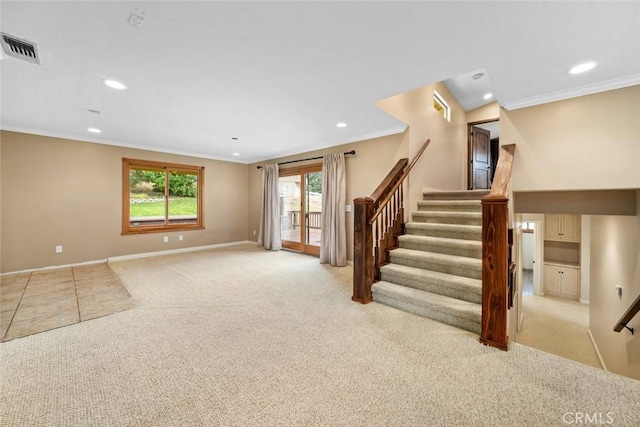 unfurnished living room featuring crown molding and light carpet