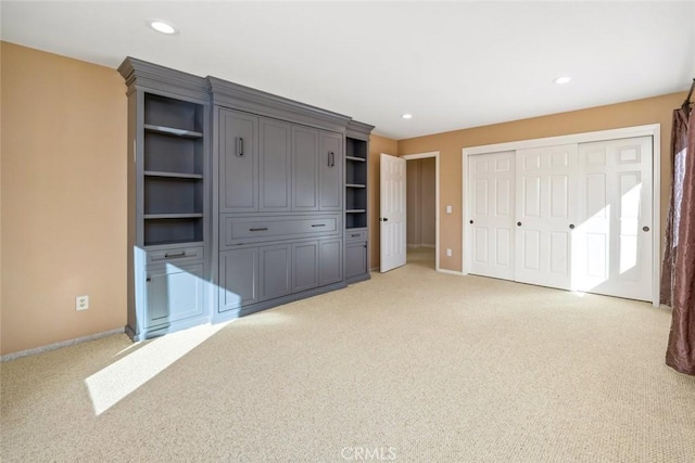 unfurnished bedroom featuring light carpet