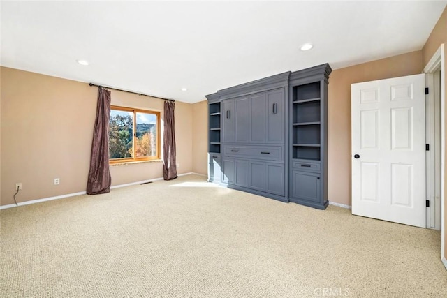 unfurnished living room with light colored carpet