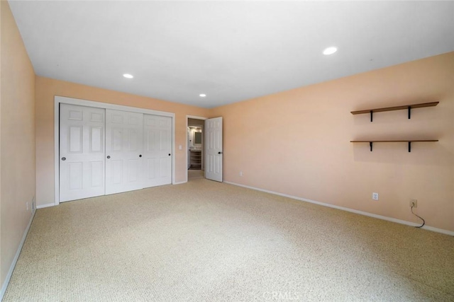 unfurnished bedroom featuring carpet floors and a closet