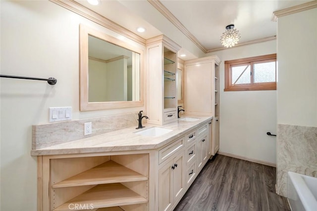 bathroom with vanity, wood-type flooring, ornamental molding, and a washtub