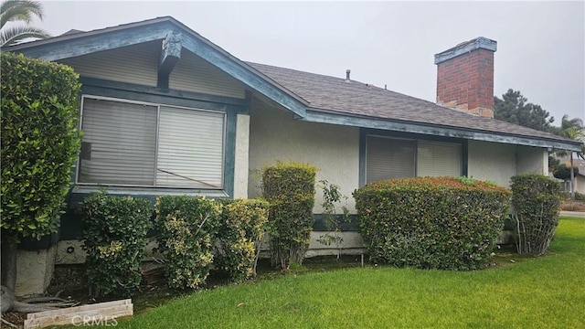 view of side of home featuring a yard