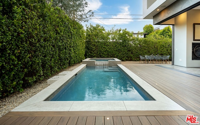 view of pool featuring an in ground hot tub and a wooden deck