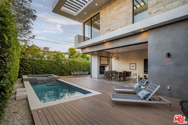 view of swimming pool with an in ground hot tub and a deck