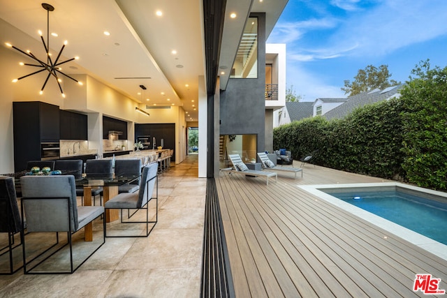 pool at dusk featuring an outdoor hangout area