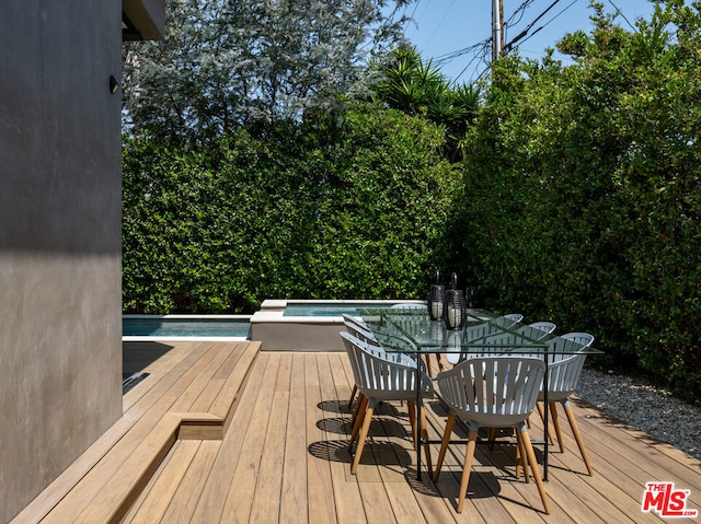 deck featuring a pool with hot tub