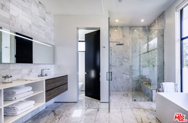 full bathroom with decorative backsplash, vanity, toilet, and independent shower and bath