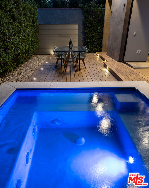 view of swimming pool featuring a deck