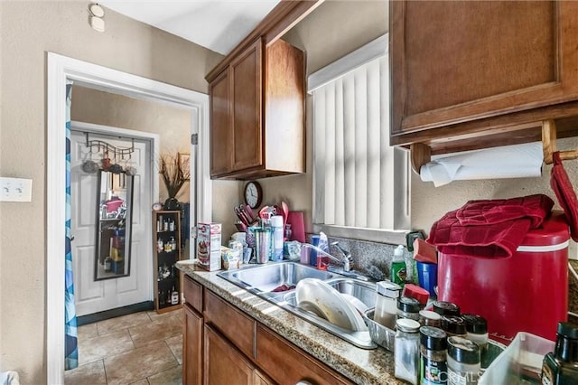 kitchen with light stone countertops and sink