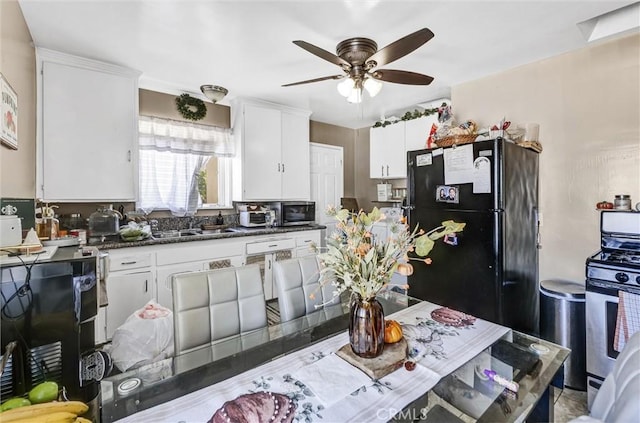 kitchen with ceiling fan, sink, white cabinetry, and stainless steel appliances