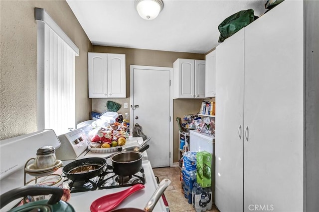 kitchen with white cabinetry and light tile patterned floors