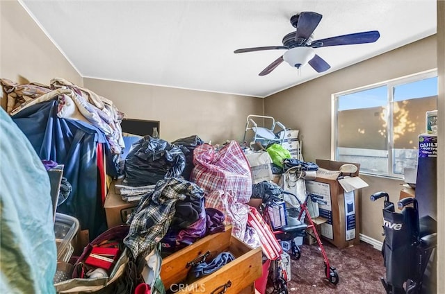 misc room featuring dark colored carpet and ceiling fan