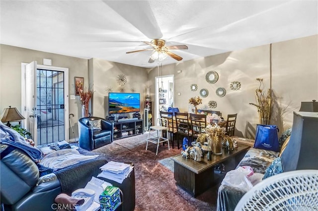 carpeted living room with ceiling fan