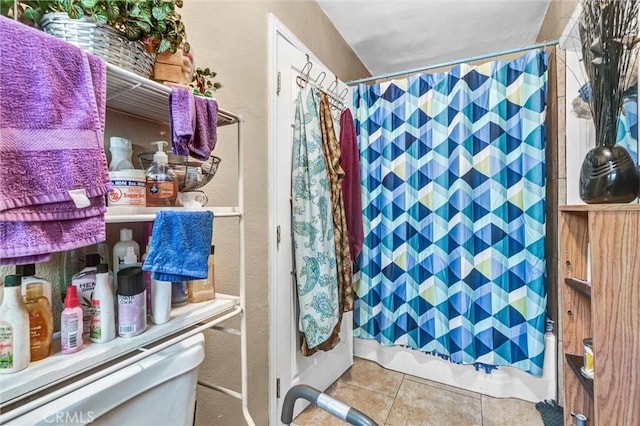 bathroom with a shower with curtain and tile patterned flooring