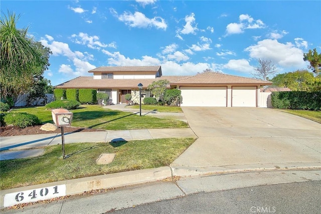 view of front of house with a garage and a front yard