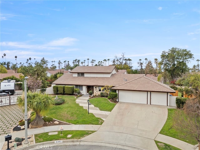 view of front of property featuring a garage and a front lawn