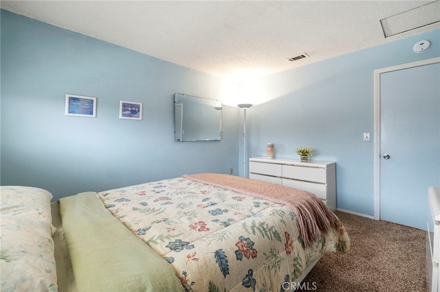 bedroom with carpet flooring and a textured ceiling