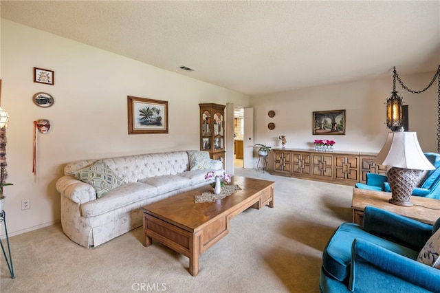 carpeted living room featuring a textured ceiling