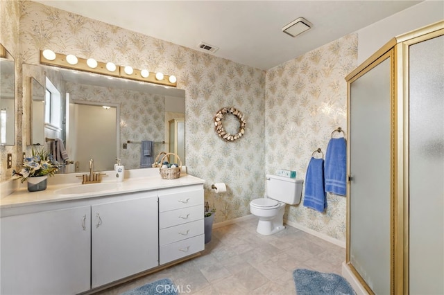 bathroom with vanity, toilet, and an enclosed shower