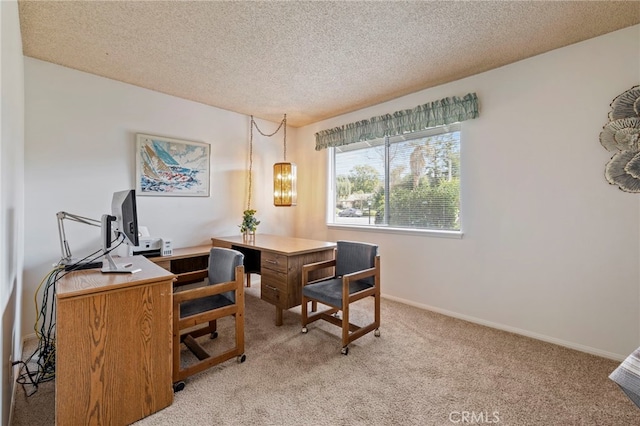 carpeted dining room featuring a textured ceiling